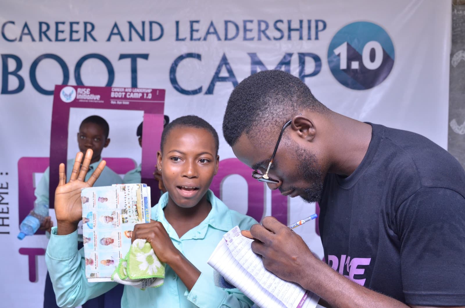 A facilitator working with a student at Aatan Baptist Comprehensive High School, 2019.