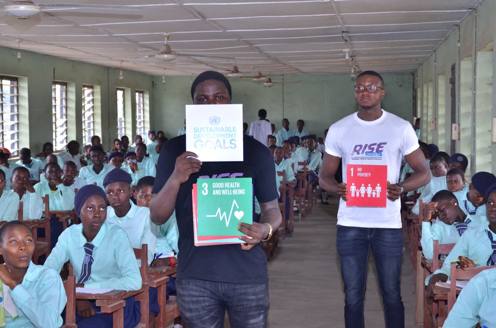Facilitators presenting Sustainable Development Goals cards at Aatan Baptist Comprehensive High School, 2019.