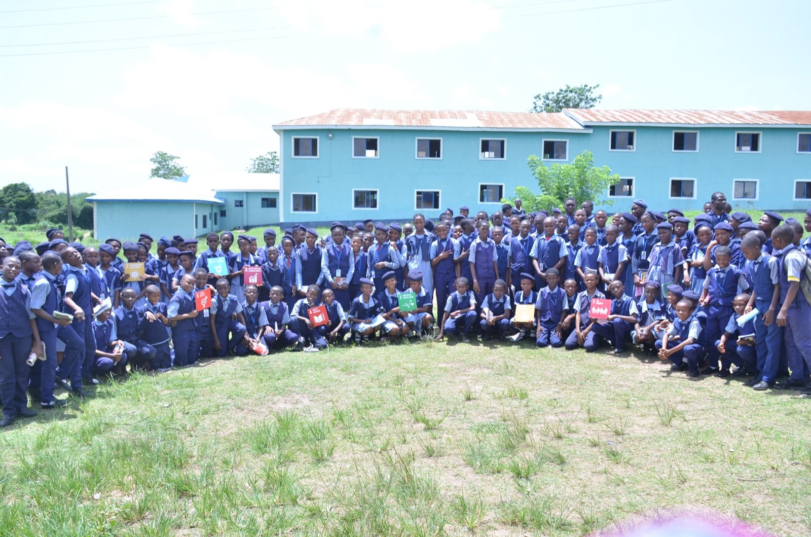 Students and facilitators gathered outside the school for a group photo, Best Legacy International Secondary School, 2019.