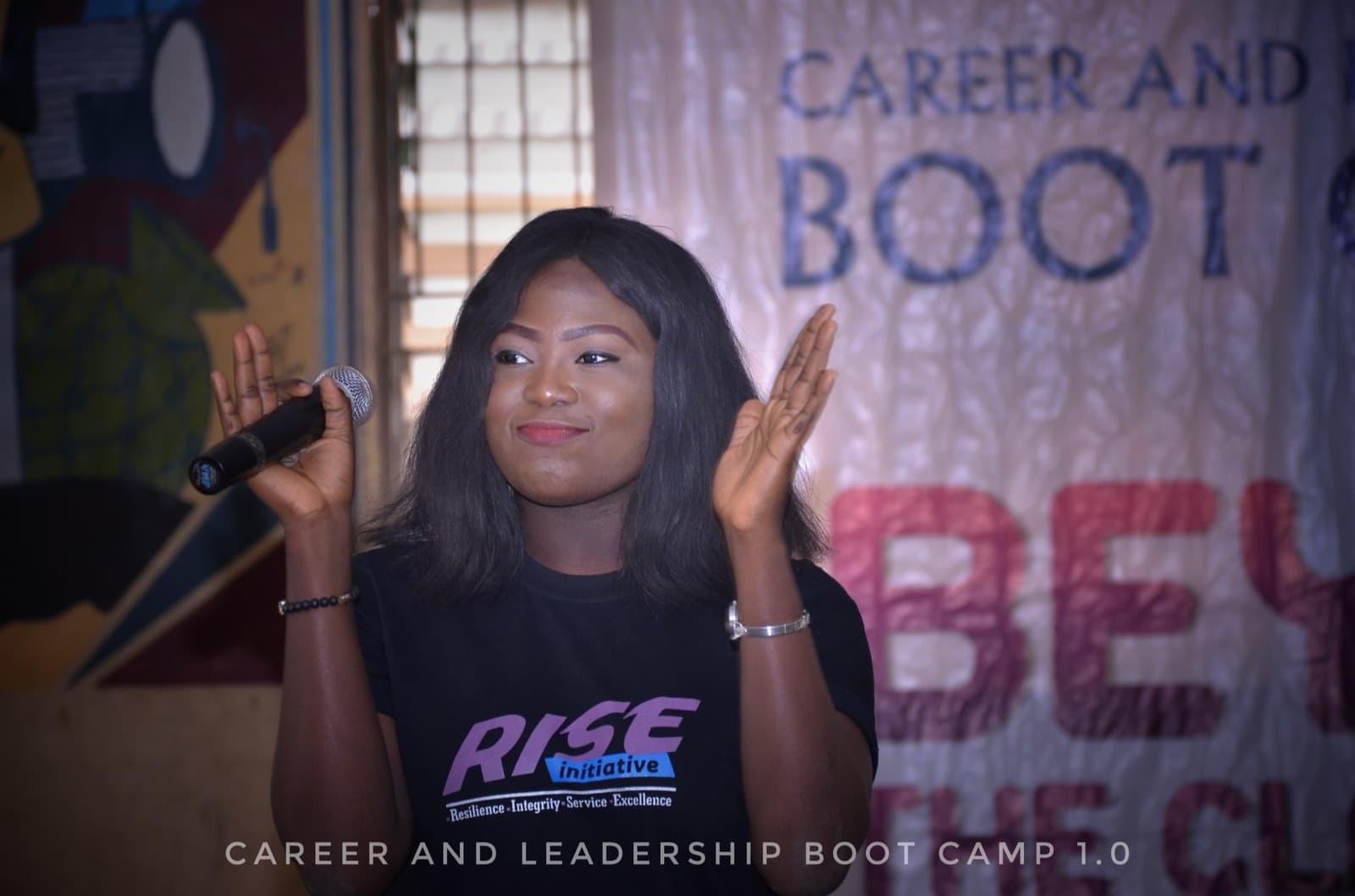 A facilitator holding a microphone at the 2019 bootcamp, SPED International Secondary School.