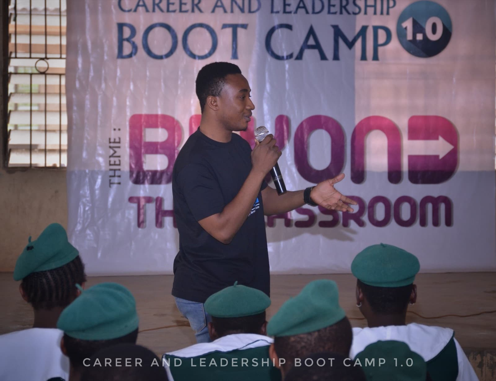 A facilitator addressing students at SPED International Secondary School, 2019.