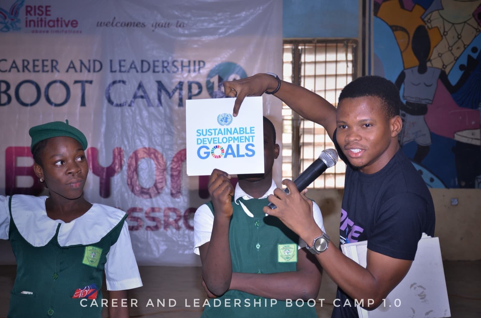 A facilitator holding a Sustainable Development Goals card at SPED International Secondary School, 2019.