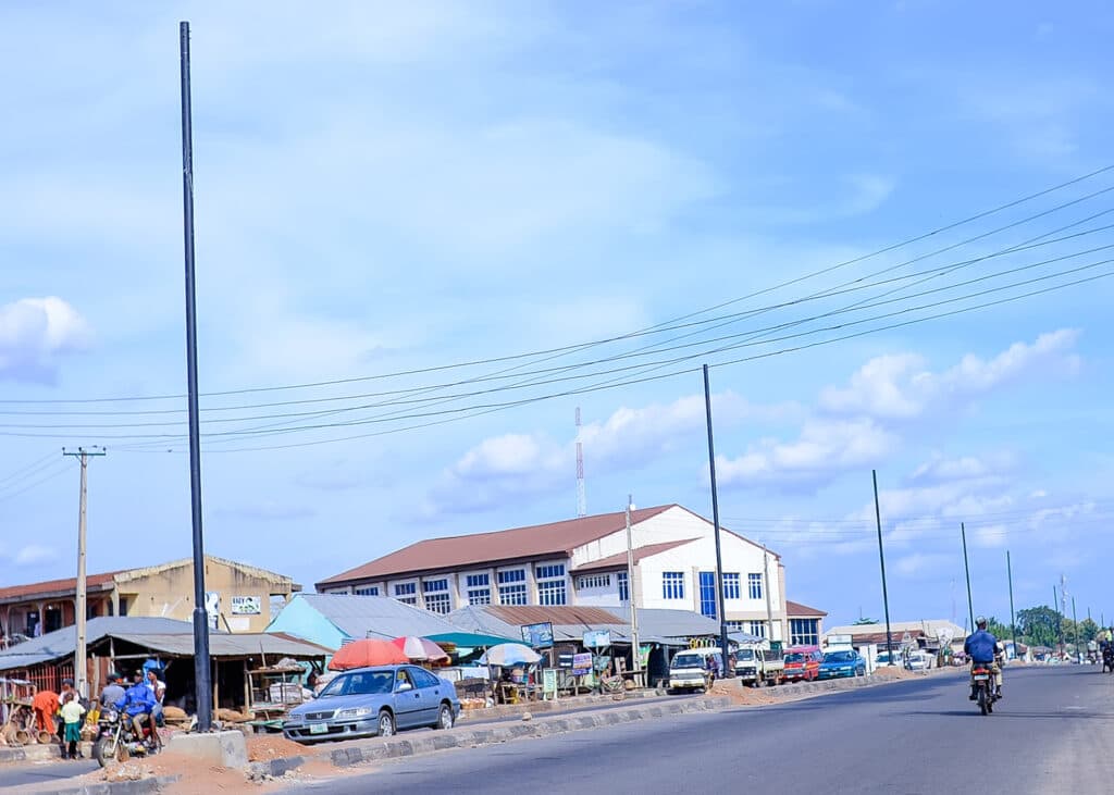 A lively street in Oyo town, with local shops, residents, and traffic